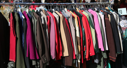 clothes hung from hangers for sale in flea market