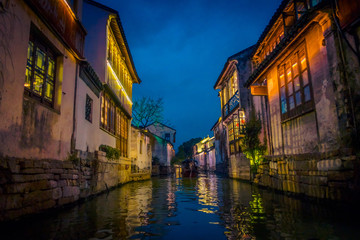 SHANGHAI, CHINA - 29 JANUARY, 2017: Beautiful evening light creates magic mood inside Zhouzhuang water town, ancient city district with channels and old buildings, charming popular tourist area