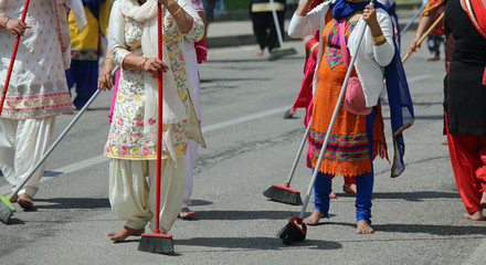 many Sikhs  women barefoot while scavenging the road