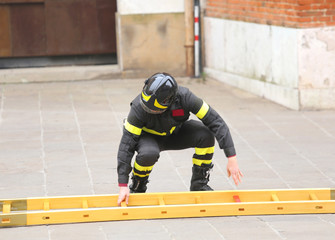 firemen during rescue operations with a wooden ladder