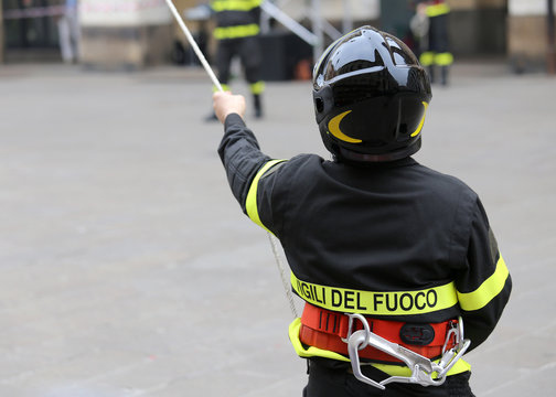 Italian firefighter with protective helmet and a rope and the wo
