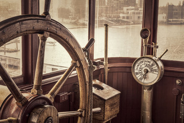 vintage ship steering wheel in sepia toning