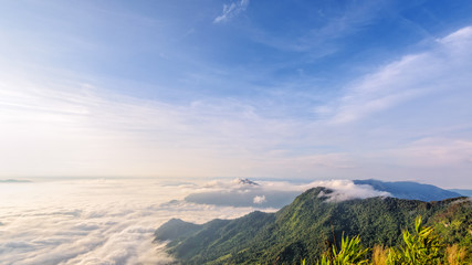 Beautiful landscape nature in morning on peak mountain with sunlight cloud fog and bright blue sky in winter at Phu Chi Fa Forest Park is a famous tourist attraction of Chiang Rai Province, Thailand