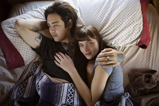 Young couple lying in bed
