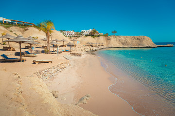 The big deserted beach. Closed beach and sun loungers. Egypt