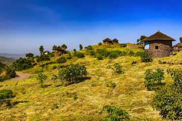 Fototapeta premium Ethiopia. Lalibela. Traditional round houses built of stone with a cone-shaped thatched roof, called 