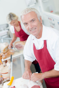 Butcher serving a female customer