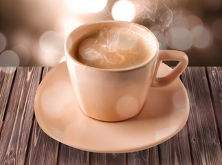 Cup of coffee with foam on light background