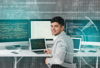 Handsome young programmer working in office