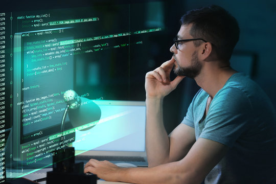 Program development concept. Young man working with computer