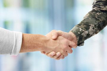 Soldier and civilian shaking hands on white background, closeup - obrazy, fototapety, plakaty