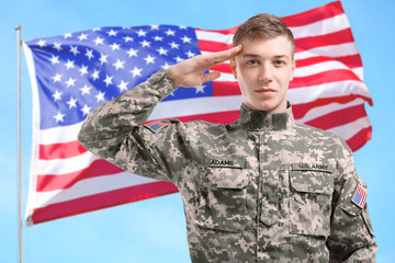 Soldier in camouflage saluting on white background