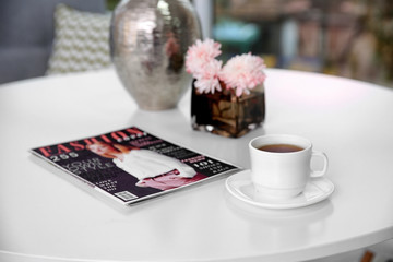 Cup of delicious tea on white table