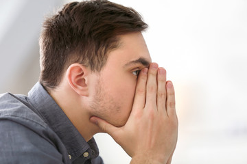 Handsome depressed man at home