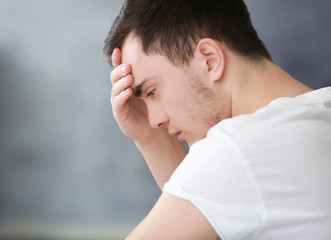 Fototapeta premium Handsome depressed man at home, closeup