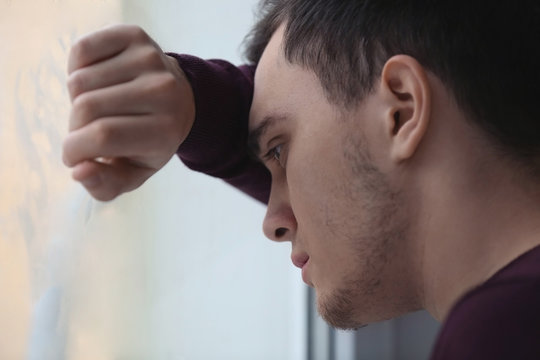Handsome depressed man at home