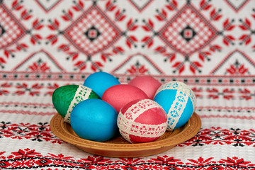 easter eggs in wooden plate on the towel