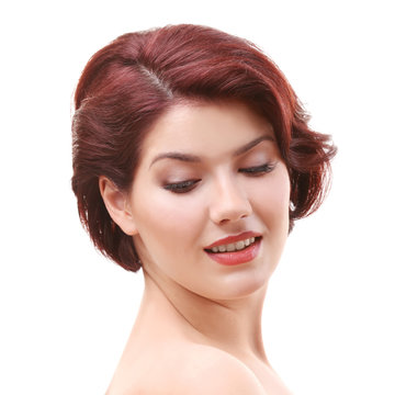 Portrait of young woman with beautiful haircut on white background
