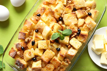 Glass dish with delicious bread pudding on napkin