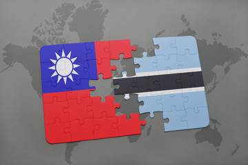 Fototapeta premium puzzle with the national flag of taiwan and botswana on a world map