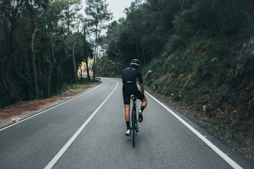 Male professional cyclist climbing in the Spanish mountains