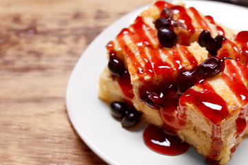 Delicious bread pudding with currant and jam on plate