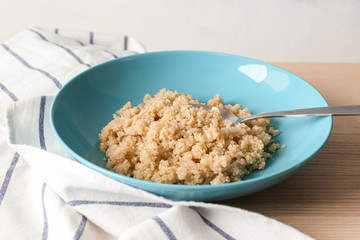 Blue plate with healthy quinoa porridge on table