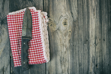 Old knife on a kitchen napkin, top view, empty space on the right