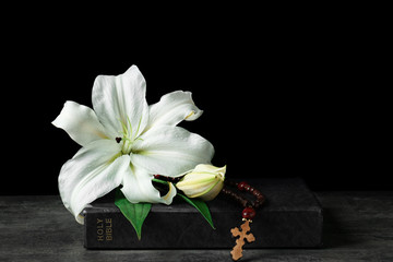 Holy Bible and Easter white lily on table