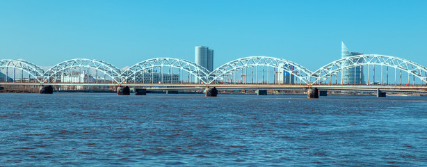 Railway bridge over Daugava river on sunny spring day. Riga. Latvia