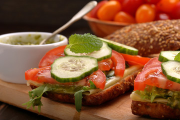 Vegetarian sandwich with pesto on wooden background
