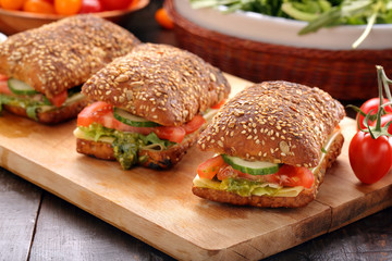 Vegetarian sandwich with pesto on wooden background