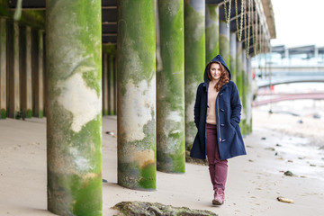 Woman portrait at low tides of Thames with green stilts