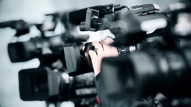Television cameras in a row broadcasting a live media event