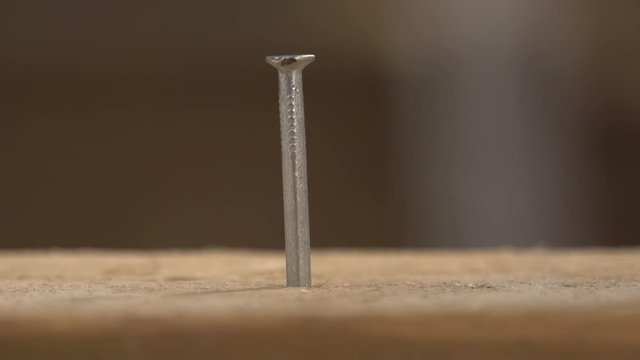 Knocks a Nail Into Wood With Hammer Part 4. Hammer a nail into a board in super slow motion