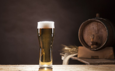 Beer barrel with beer mug on brown background