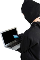 Hacker using laptop and credit card