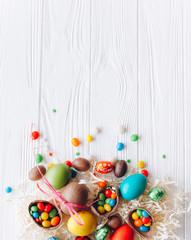  colored easter eggs and  on white wooden background