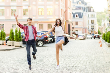 Fototapeta premium Happy smiling couple having fun in the street on summertime. .