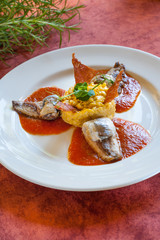 Sardine with anchovies with pumpkin risotto and tomato sauce