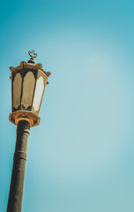Fototapeta na wymiar old lamp column under blue sky