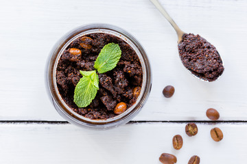 Organic spa with coffee scrub in cosmetic set on table top view