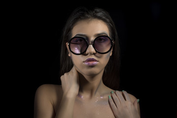 Portrait of a young girl with artistic make up with sunglasses 