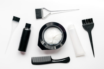 Tools for hair dye in barbershop on white background top view
