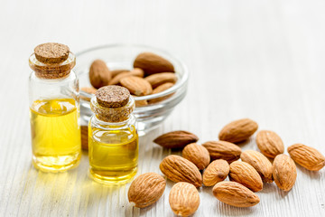 cosmetic set with almond oil on wooden table background