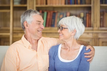 Senior couple sitting together on sofa in living room