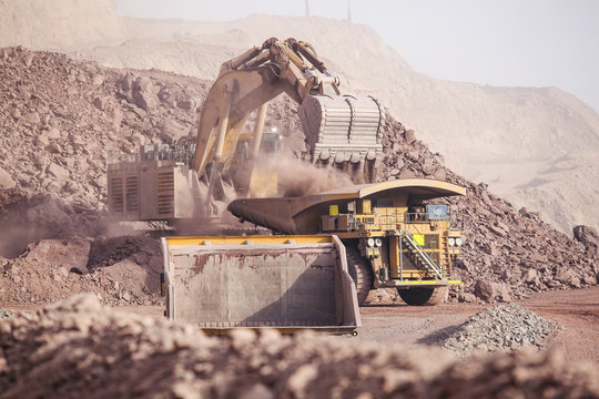 Loading of copper ore on very big dump-body truck