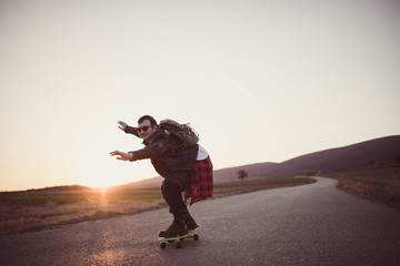Hipster man riding a skateboard