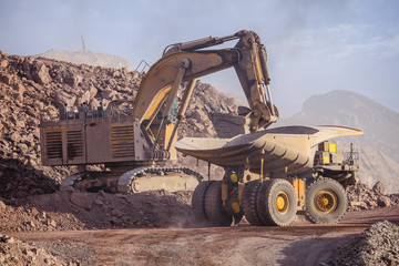 Fototapeta premium Loading of copper ore on very big dump-body truck