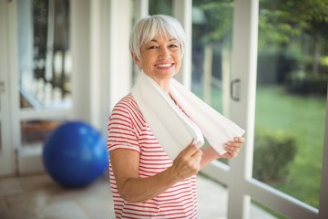 Portrait of senior woman with towel at home